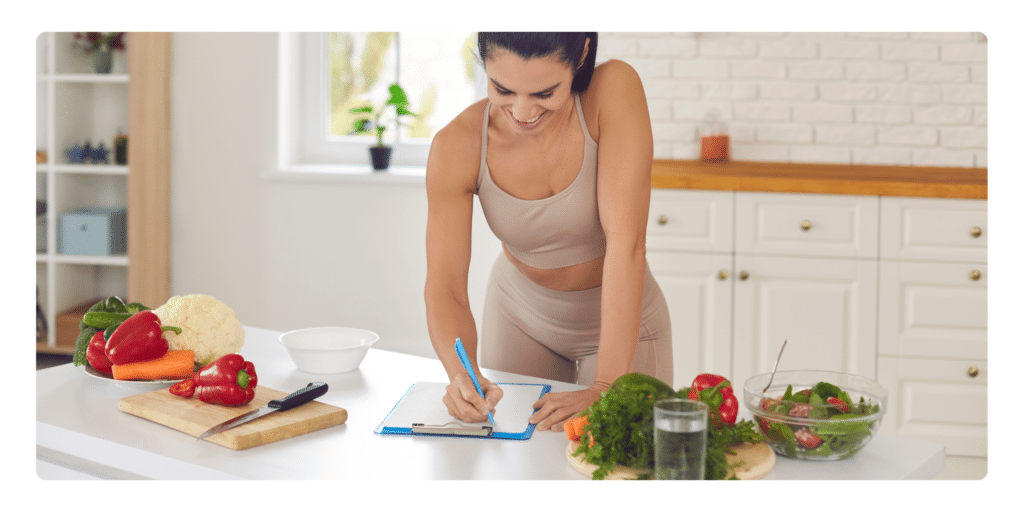 Young woman writing a list in the kitchen 